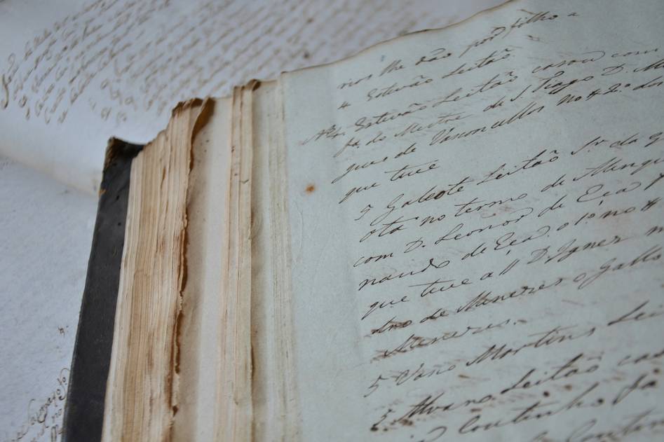 Scholar examining medieval texts in a library
